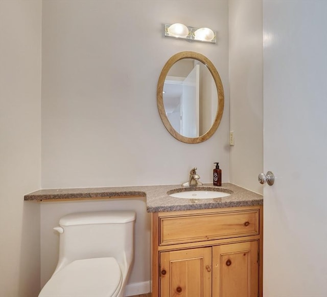 bathroom featuring vanity and toilet