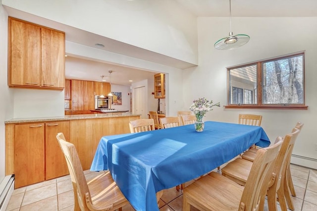 dining room featuring high vaulted ceiling, a baseboard heating unit, baseboard heating, and light tile patterned floors