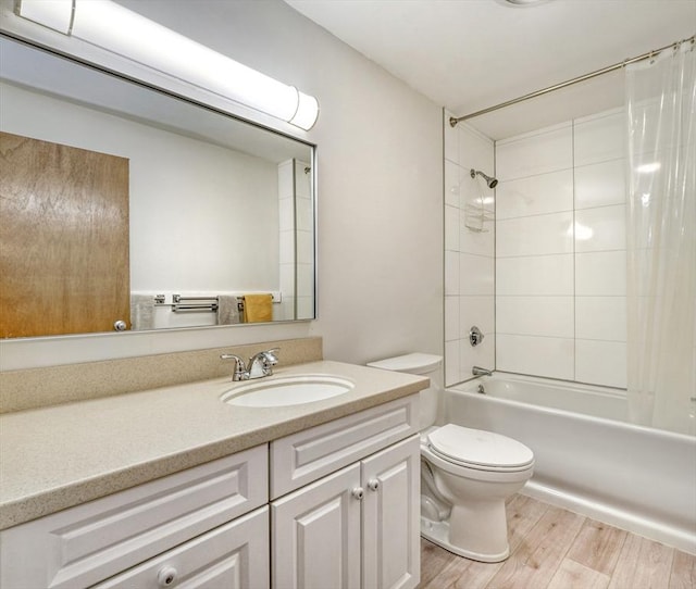 bathroom with vanity, shower / bath combo, wood finished floors, and toilet