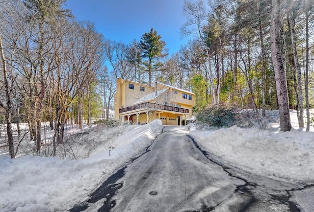 view of snowy exterior featuring a garage