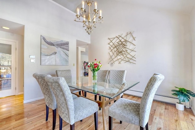 dining area with light wood-style floors, baseboards, and a chandelier