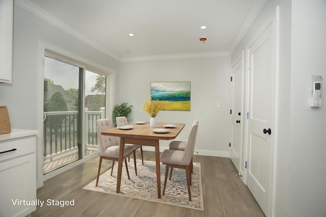 dining room with crown molding, recessed lighting, baseboards, and wood finished floors