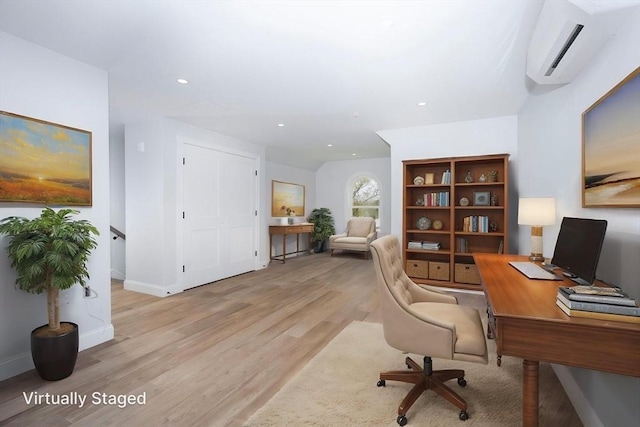 office area featuring recessed lighting, baseboards, an AC wall unit, and light wood-type flooring