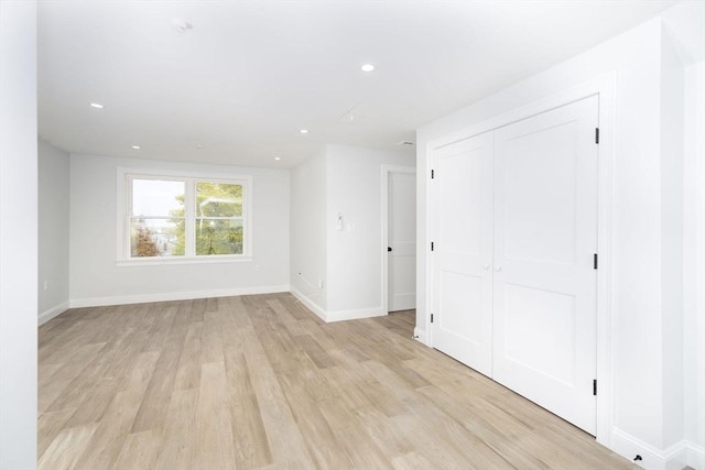 unfurnished room with recessed lighting, baseboards, and light wood-type flooring