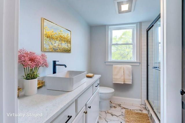 full bathroom featuring vanity, a stall shower, toilet, and marble finish floor