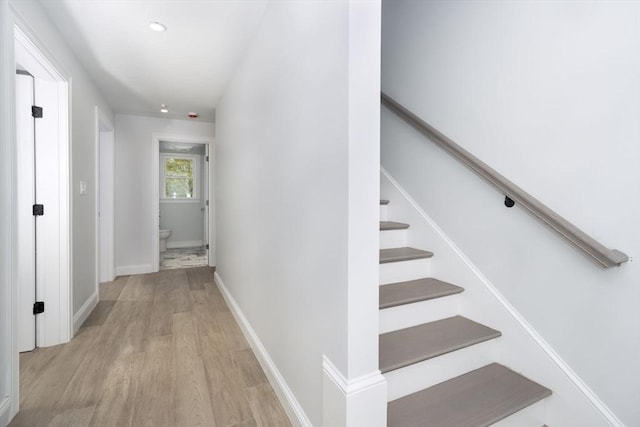 stairs featuring baseboards and wood finished floors