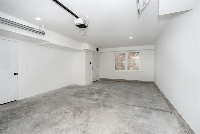 garage featuring recessed lighting, baseboards, and a garage door opener