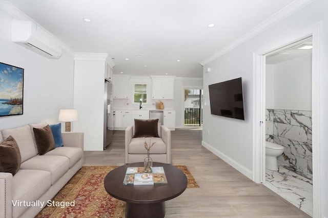 living area featuring an AC wall unit, recessed lighting, ornamental molding, and light wood-type flooring