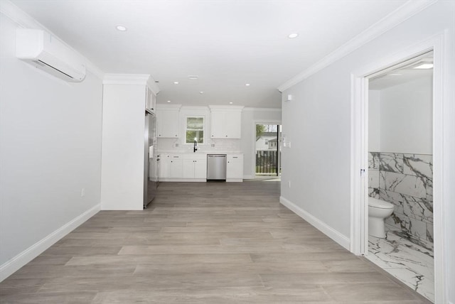 interior space with crown molding, a wall mounted air conditioner, a sink, light wood finished floors, and recessed lighting