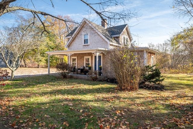 view of front of home with covered porch and a front lawn