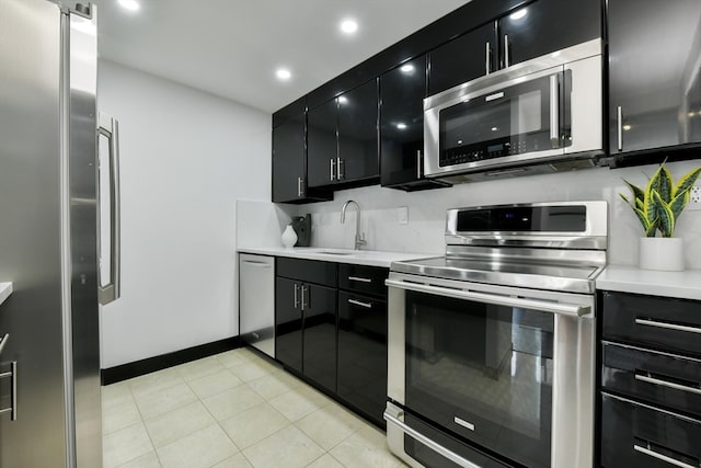 kitchen with decorative backsplash, stainless steel appliances, light tile patterned flooring, and sink