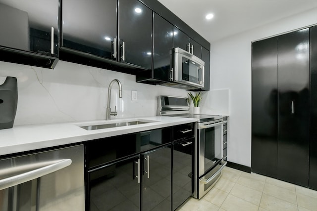 kitchen featuring light tile patterned floors, stainless steel appliances, backsplash, and sink