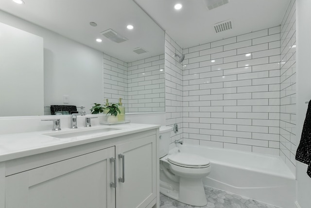 full bathroom featuring tiled shower / bath combo, vanity, and toilet