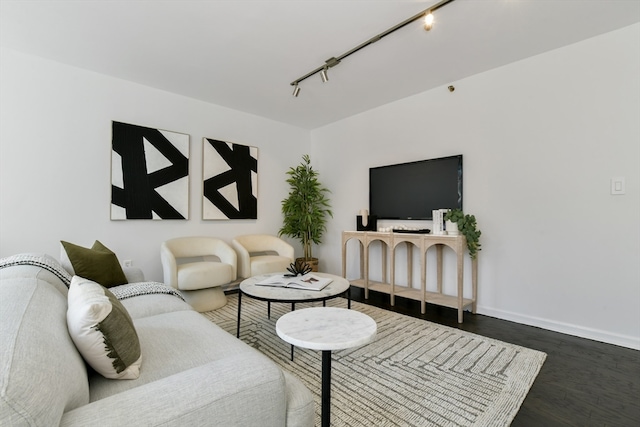 living room featuring track lighting and dark hardwood / wood-style flooring