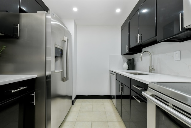 kitchen featuring light tile patterned floors, appliances with stainless steel finishes, backsplash, and sink