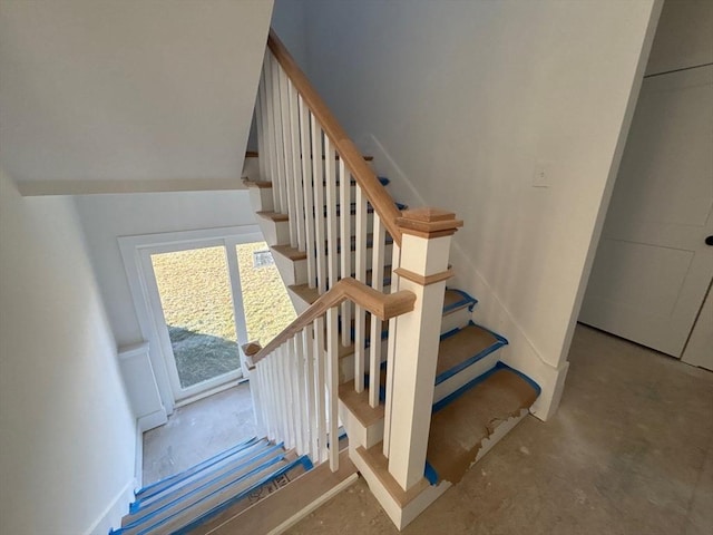 stairs featuring concrete floors