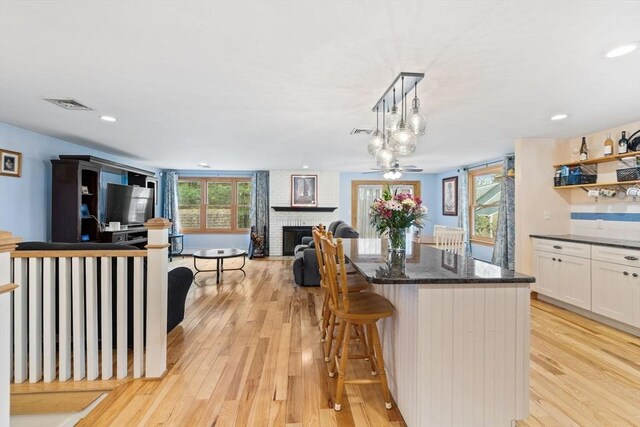 11 Michael Rd, Bourne, MA 02559 - kitchen with white cabinets, a wealth of natural light, and light wood finished floors