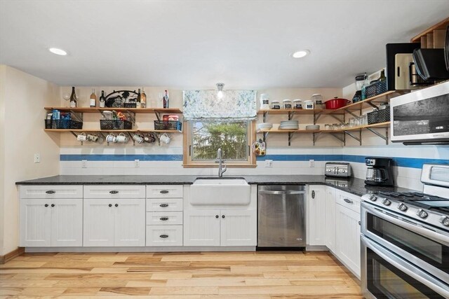 11 Michael Rd, Bourne, MA 02559 - kitchen with open shelves, light wood-style flooring, stainless steel appliances, and a sink