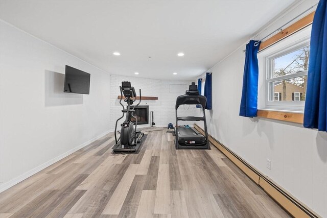 11 Michael Rd, Bourne, MA 02559 - exercise room featuring baseboards, recessed lighting, light wood-style floors, baseboard heating, and a brick fireplace