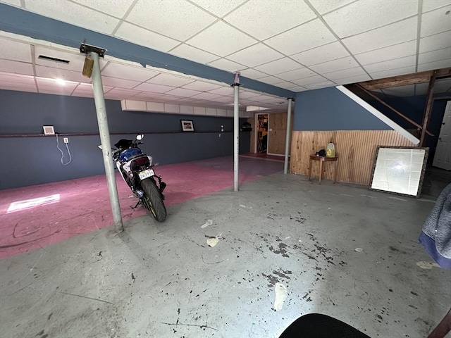 finished basement featuring a drop ceiling