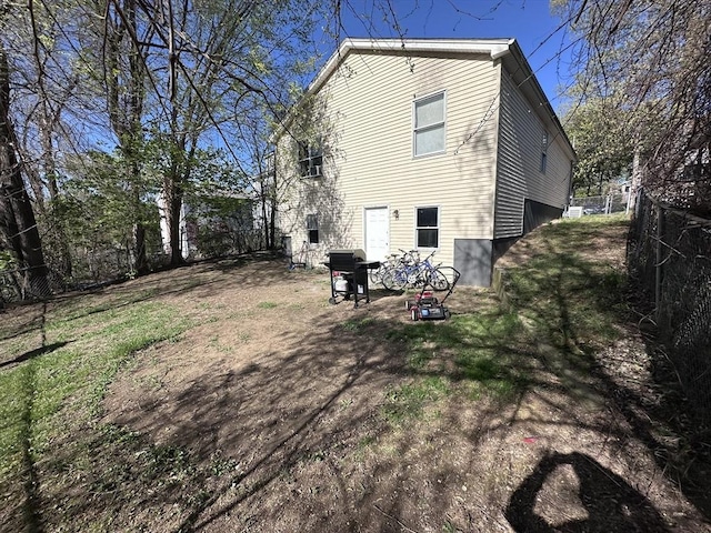 rear view of property with fence