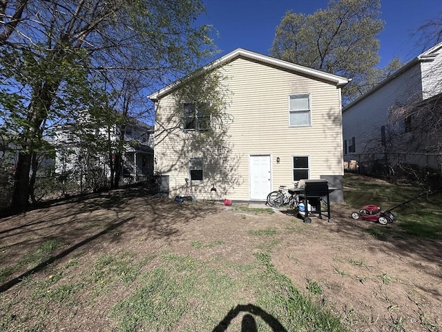 back of house with fence