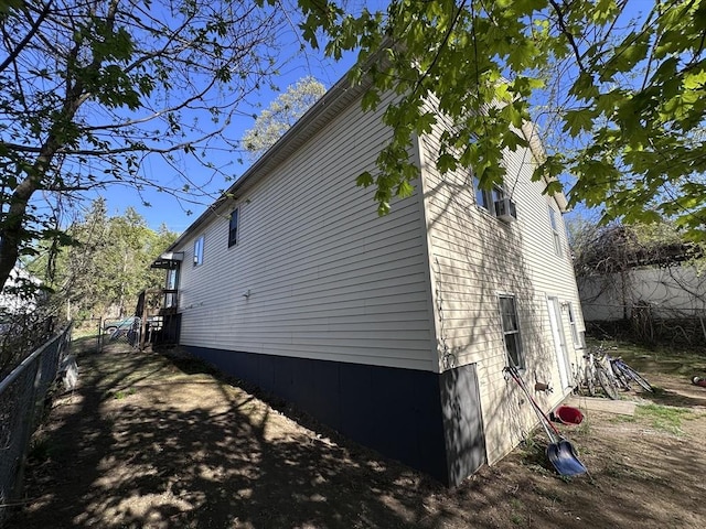 view of side of home with fence
