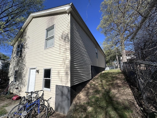 view of home's exterior featuring fence