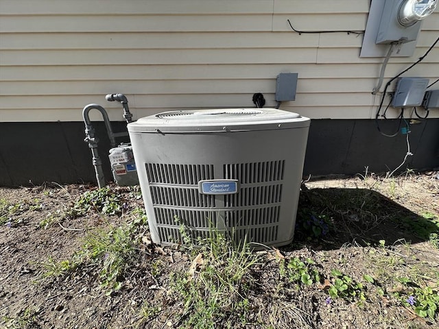 exterior details featuring central AC unit and electric meter