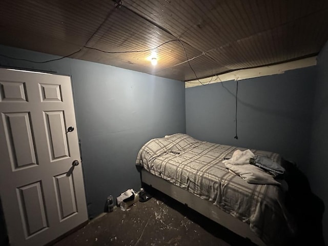 bedroom featuring unfinished concrete floors