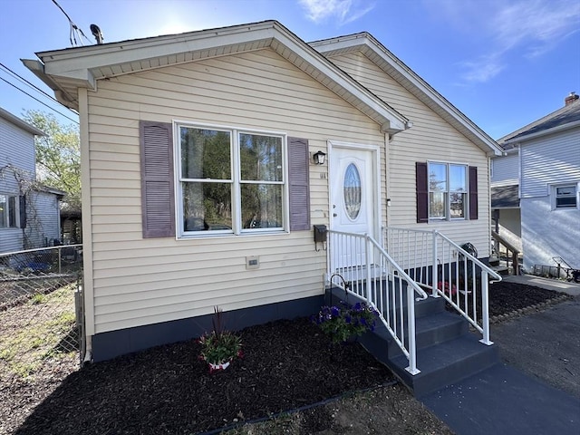 bungalow-style house with fence