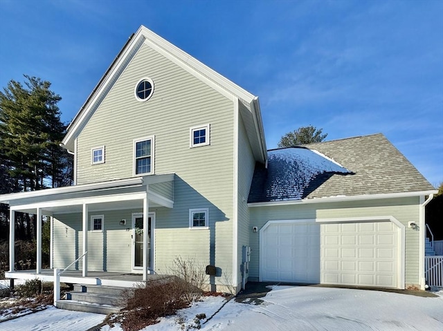 exterior space with covered porch and a garage