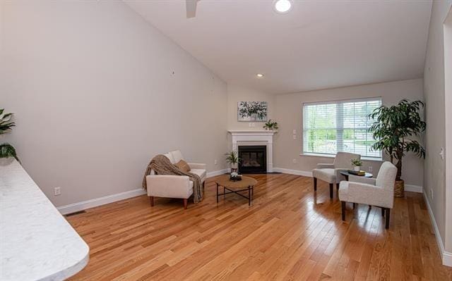 41 Winchester Unit 0, Hampstead, NH 03826 - sitting room with vaulted ceiling, light wood-style floors, a glass covered fireplace, baseboards, and recessed lighting