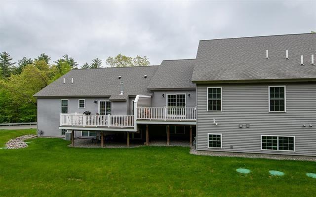 41 Winchester Unit 0, Hampstead, NH 03826 - rear view of property with a wooden deck, a lawn, central air condition unit, and roof with shingles