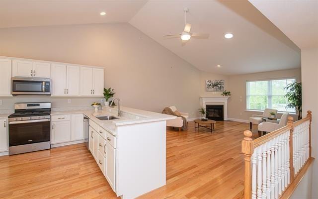 41 Winchester Unit 0, Hampstead, NH 03826 - kitchen featuring appliances with stainless steel finishes, a sink, vaulted ceiling, a peninsula, and white cabinets