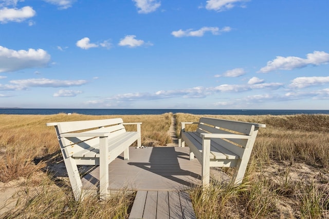 view of home's community with a deck with water view