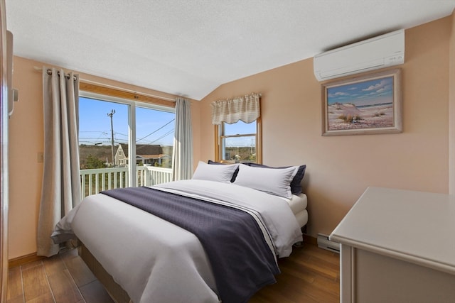 bedroom with dark hardwood / wood-style floors, vaulted ceiling, baseboard heating, and a wall mounted AC