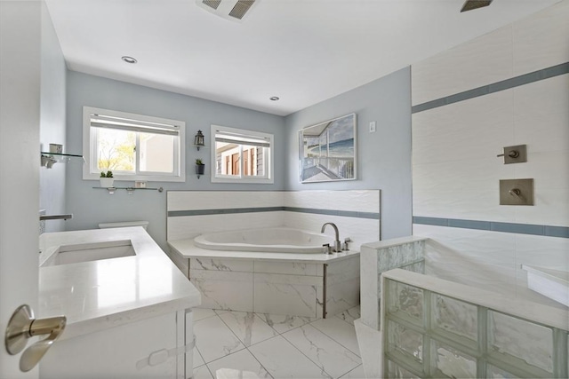 bathroom with a garden tub, visible vents, marble finish floor, vanity, and walk in shower