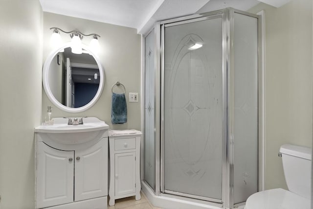 bathroom featuring vanity, toilet, and a shower stall