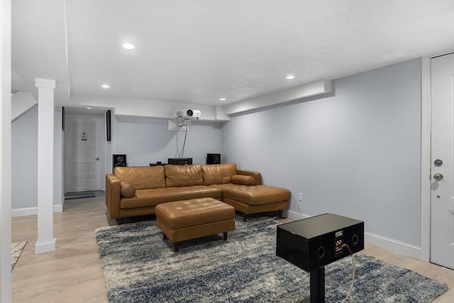 living area with recessed lighting, baseboards, and light wood-type flooring