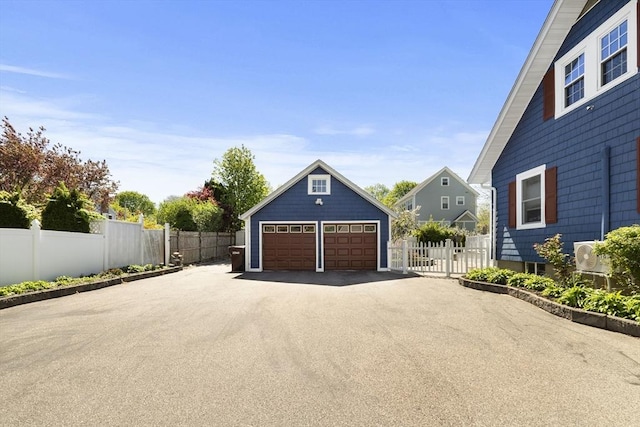 detached garage featuring fence