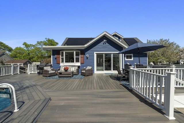 wooden terrace with an outdoor living space and outdoor dining area