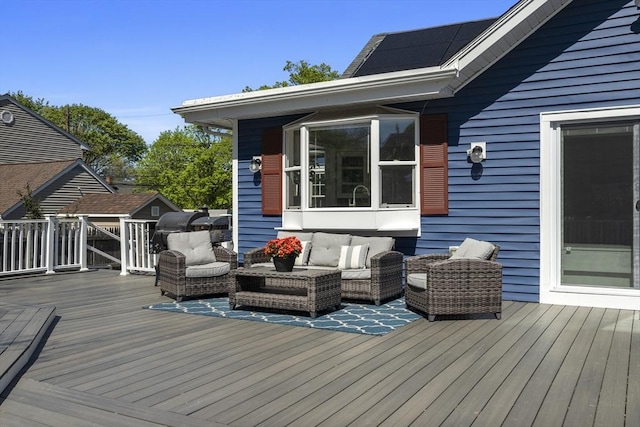 wooden terrace featuring an outdoor living space