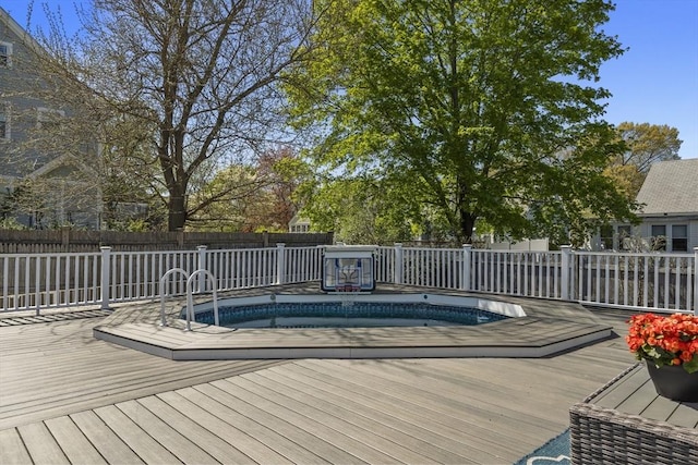 wooden deck with fence and a fenced in pool