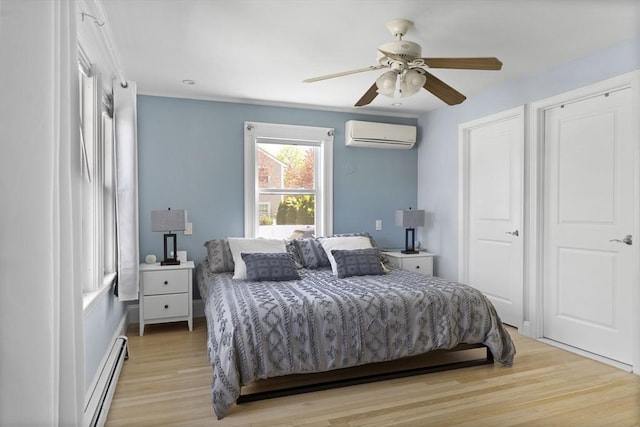 bedroom with a ceiling fan, a wall unit AC, a baseboard heating unit, and light wood finished floors