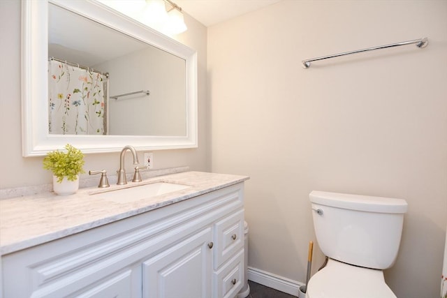 bathroom featuring vanity and toilet