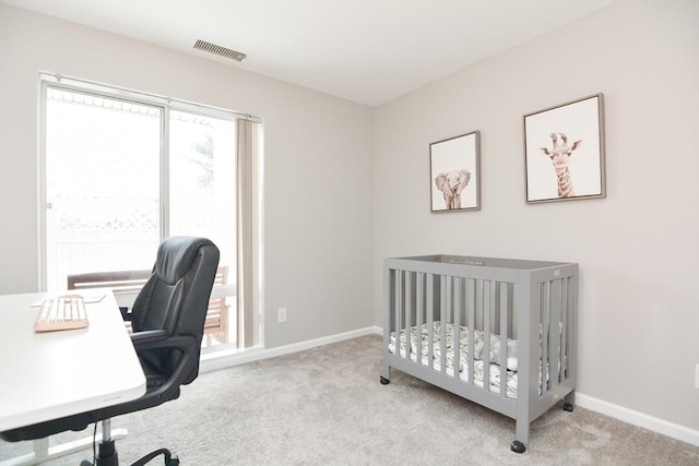 carpeted bedroom with a crib