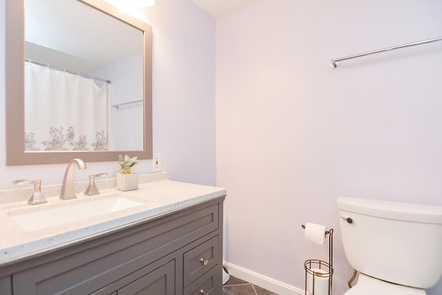 bathroom with vanity, tile patterned floors, and toilet