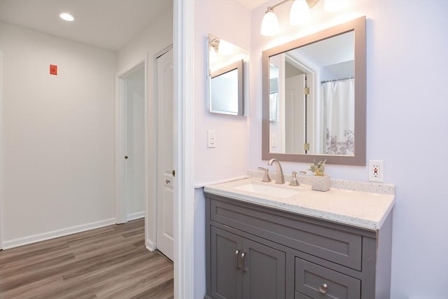 bathroom with vanity and wood-type flooring