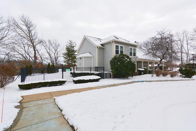 snow covered property featuring central air condition unit